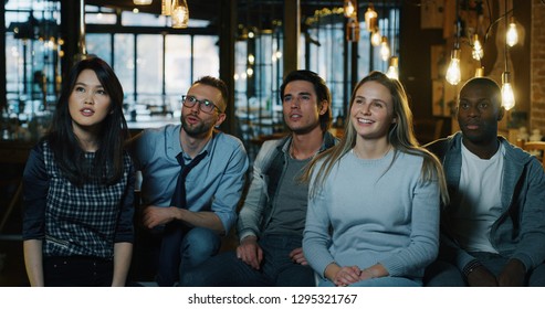 Group Of Happy College Friends  Watching Tv Together In A Pub.  Concept Of Entertainment, Friendship, Student Life