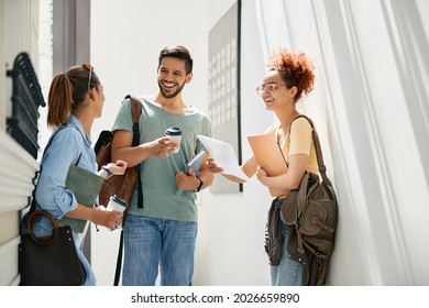 Group Of Happy College Students Drinking Coffee And Communicating In A Hallway. 