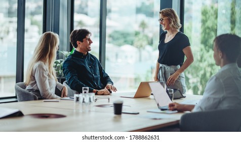 Group Of Happy Corporate People In A Meeting. Business Man And Woman Discussing Business In Office Meeting.