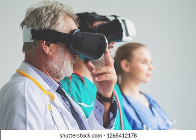 Group Of Happy Doctor Surgeon And Nurse With VR Headset, Virtual Reality Technology On White Background, Healthcare And Medical Concept