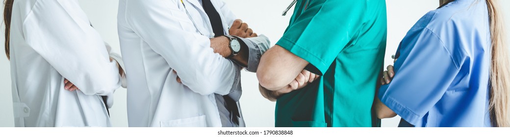 Group Of Happy Doctor Surgeon And Nurse Cross One's Arm Together For Teamwork In Meeting On White Background, Healthcare And Medical Concept