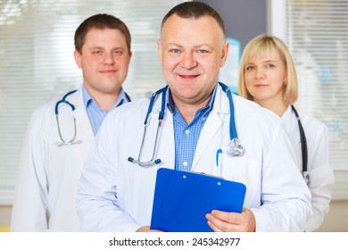 Group of happy doctors looking at camera.