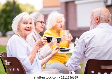 Group of happy elderly people bonding outdoors at the bar cafeteria - Old people in the age of 60, 70, 80 having fun and spending time together, concepts about elderly, seniority and wellness aging - Powered by Shutterstock