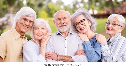 Group of happy elderly people bonding outdoors at the park - Old people in the age of 60, 70, 80 having fun and spending time together, concepts about elderly, seniority and wellness aging - Powered by Shutterstock