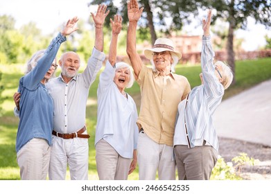 Group of happy elderly people bonding outdoors at the park - Old people in the age of 60, 70, 80 having fun and spending time together, concepts about elderly, seniority and wellness aging - Powered by Shutterstock