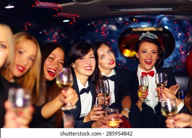 Group Of Happy Elegant Women Clinking Glasses In Limousine, Hen Party