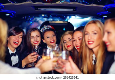 Group Of Happy Elegant Women Clinking Glasses In Limousine, Hen Party