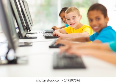 Group Of Happy Elementary School Students In Computer Room