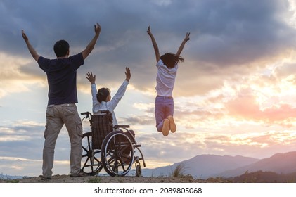 Group of Happy Family with mother Sitting in wheelchair raised hands on mountain at sunset background. - Powered by Shutterstock