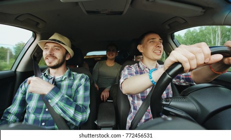 Group Of Happy Friends In Car Singing And Dancing While Drive Road Trip