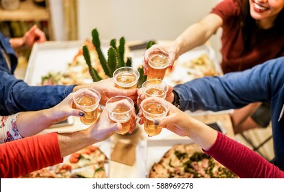 Group Of Happy Friends Cheering At Home With Beer - Young People Having Fun Together Eating Italian Pizza Take Away - Dinner,party And Friendship Concept - Focus On Glasses