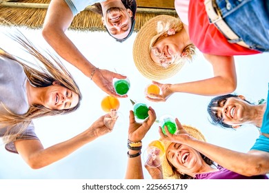 Group of happy friends cheering with tropical cocktails at beach party - Young and senior people having fun in summertime weekend - Family and summer vacation concept - Powered by Shutterstock