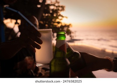 Group of happy friends cheering with tropical cocktails and beers at beach party, Young people having fun in Goa, Youth and summer vacation concept	 - Powered by Shutterstock