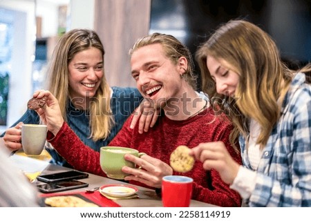 Group of Happy friends drinking cappuccino at coffee bar restaurant - People talking and having fun together at breakfast at home - Friendship concept with happy men and women at cafe