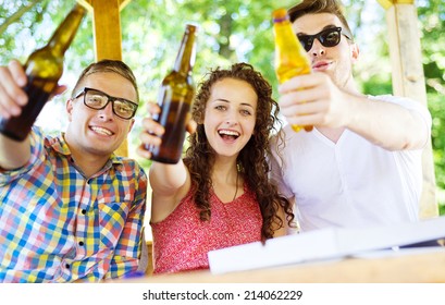 Group Of Happy Friends Drinking And Having Fun In Pub Garden