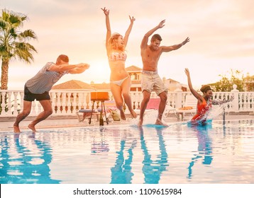 Group Of Happy Friends Drinking Jumping In Pool Sunset Party - Young Diverse Culture People Having Fun In Tropical Vacation - Holiday, Youth And Friendship Concept - Main Focus On Center Guys