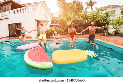 Group Of Happy Friends Drinking Jumping In Pool At Sunset Party - Young Diverse Culture People Having Fun In Tropical Vacation - Holiday, Youth And Friendship Concept - Main Focus On Guys Faces