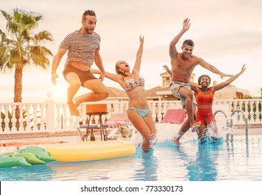 Group Of Happy Friends Drinking Jumping In Pool Sunset Party - Young Diverse Culture People Having Fun In Tropical Vacation - Holiday, Youth And Friendship Concept - Main Focus On Right Man Face