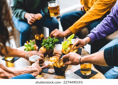 Group of happy friends eating food and drinking beer at brewery pub restaurant- Young people enjoying happy hour with appetizer gourmet at bar table- Life Style Dining and Beverage concept - Shutterstock ID 2274490193