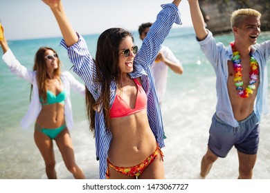Group of happy friends enjoying the beach at summer - Shutterstock ID 1473067727