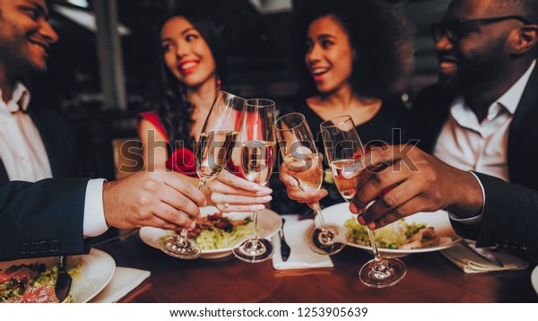 Group Happy Friends Enjoying Dating in Restaurant.\
Double Couple Dating in Restaurant. Romantic Couple in Love Dating.\
Friends in a Restaurant Making Order. Romantic Concept. Pouring\
Glasses Wine