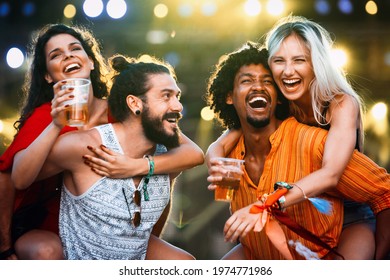 Group of happy friends hanging out and enjoying drinks, festival - Shutterstock ID 1974771986