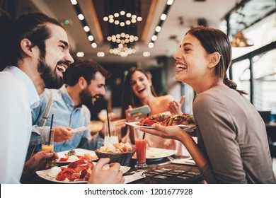Group of Happy friends having breakfast in the restaurant