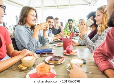 Group of happy friends having coffee break at bar cafeteria - Young students people enjoying breakfast - Friendship and good mood concept - Focus on left woman drinking cappuccino - Powered by Shutterstock