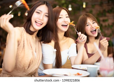 Group Of Happy Friends Having Dinner In The Restaurant