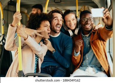 Group of happy friends having fun while traveling by bus and talking selfie with mobile phone.  - Powered by Shutterstock