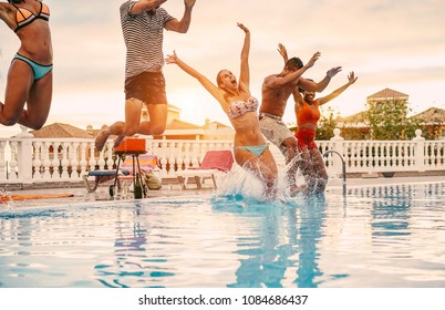 Group Of Happy Friends Jumping In Pool Party At Sunset - Young Diverse Culture People Having Fun In Tropical Vacation - Holiday, Youth Lifestyle And Friendship Concept - Main Focus On Blond Woman Face