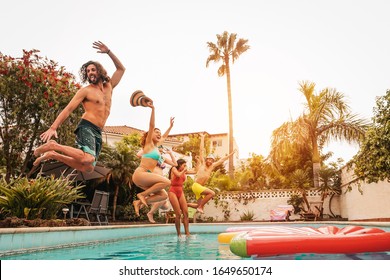 Group Happy Friends Jumping In Pool At Sunset Time - Crazy Young People Having Fun Making Party In Exclusive Tropical House - Summer Holidays Vacation And Youth Culture Lifestyle Concept