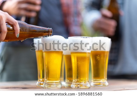 Group of happy friends living healthy lifestyle and relax Cheering with beer and And Drinking Beer
