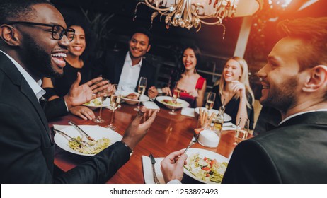 Group Of Happy Friends Meeting And Having Dinner. Celebrating With Friends. Party Dinner Table. Enjoying Meal In Restaurant. Restaurant Chilling Out Classy Lifestyle Reserved Concept.