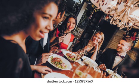 Group Of Happy Friends Meeting And Having Dinner. Celebrating With Friends. Party Dinner Table. Enjoying Meal In Restaurant. Restaurant Chilling Out Classy Lifestyle Reserved Concept.