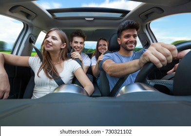 Group Of Happy Friends On A Car