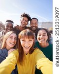 Group of happy friends posing for a selfie on a spring day as they party together outdoors. Group of multicultural friends having a good time together on the weekend.