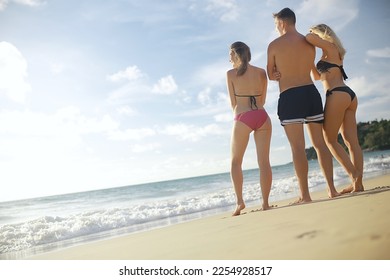 group of happy friends relaxing by the sea - Shutterstock ID 2254928517