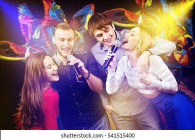 Group Of Happy Friends Singing In Karaoke Night Club