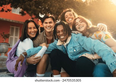 Group of happy friends smiling and bonding while participating in a study abroad program outdoors. - Powered by Shutterstock