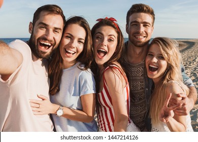 Group of happy friends spending time together at the beach, taking a selfie - Powered by Shutterstock