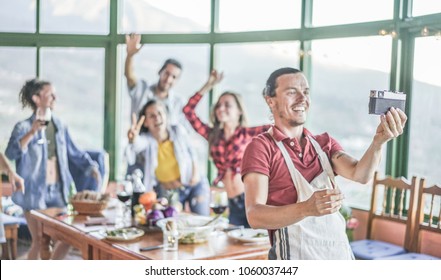 Group Of Happy Friends Taking Selfie Photo With Vintage Camera At Party Dinner - Trendy People Having Fun Dining In Patio Terrace - Focus On Camera - Youth Lifestyle, Summer And Friendship Concept