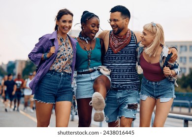 Group of happy friends walking embraced while attending open air music festival at summer.  - Powered by Shutterstock