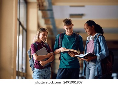 Group of happy high school students learning in a hallway. Copy space.  - Powered by Shutterstock