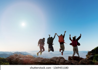 Group Of Happy Hiker Jumping On The Hill. Hiking Holiday, Wild Adventure