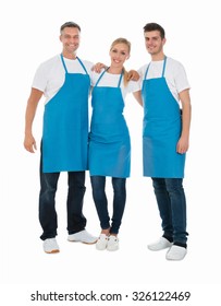 Group Of Happy Janitors Wearing Blue Apron Over White Background