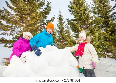 Group Of Happy Kids Build Behind Snow Wall