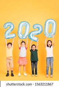 Group Of Happy Kids Celebrating And Showing 2020 New Year Concepts