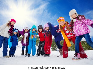 Group Of Happy Kids, Having Fun On Snow Day, Holding Hands, Laughing And Smiling