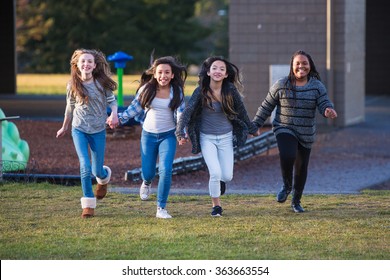 Group Of Happy Kids Running Outside